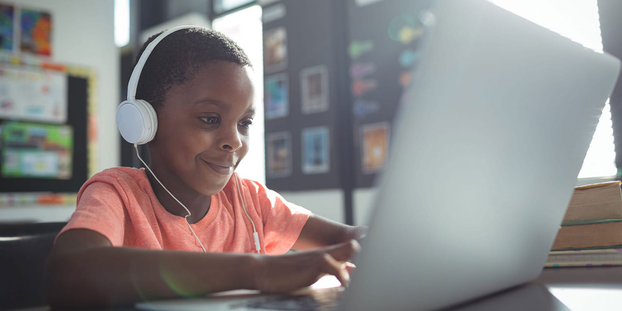 Student playing on laptop